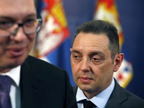 FILE - Serbia Defense Minister Aleksandar Vulin, right, walks behind Serbian President Aleksandar Vucic in Belgrade, Serbia, Monday, April 23, 2018. Vulin, said Monday, July 11, 2022 he is advocating a "Serbian world" that would unite all Serbs in the Balkans in a single state, rejecting a U.S. warning that such calls could further fuel tensions in the still volatile region.