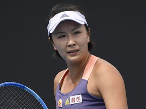 FILE - China's Peng Shuai reacts during her first round singles match against Japan's Nao Hibino at the Australian Open tennis championship in Melbourne, Australia on Jan. 21, 2020. Four activists wearing "Where is Peng Shuai?" T-shirts were stopped by security at Wimbledon Monday, July 4, 2022 and had their bags searched. Peng is a retired professional tennis player from China who last year accused a former high-ranking member of the country's ruling Communist Party of sexual assault.