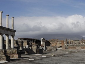 FILE - Clouds hang over the Vesuvius volcano in Pompeii, southern Italy, Jan. 25, 2021. An American tourist had to be rescued on Mount Vesuvius near Naples after he apparently slipped into the volcano's crater while trying to recover his fallen cellphone, news reports and the association of Vesuvius park guides said. The tourist and family members were cited by Carabinieri police because they went off the authorized path to get closer to the crater on Saturday, July 9, 2022 apparently to take a selfie, Italian news reports said.