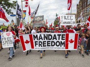 People protest and march on Wellington street against COVID-19 health measures during Canada Day in Ottawa, Ontario, on Friday July 1, 2022.