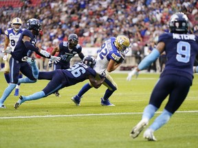 Winnipeg Blue Bombers' Drew Wolitarsky runs the ball in for a touchdown as Toronto Argonauts' Eric Sutton (36) fails the tackle during the first half of CFL football action in Toronto, Monday, July 4, 2022.