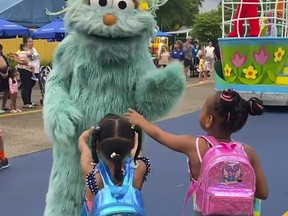 In this image from video provided by Jodi Brown, posted to Instagram on Saturday, July 16, 2022, a performer dressed as the character Rosita waves off Brown's daughter and another 6-year-old Black girl at the Sesame Place amusement park in Langhorne, Pa.