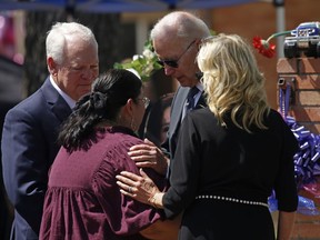 FILE - President Joe Biden and first lady Jill Biden comfort principal Mandy Gutierrez as superintendent Hal Harrell stands next to them, at the memorial outside Robb Elementary School to honor the victims killed in this week's school shooting in Uvalde, Texas, on May 29, 2022. The attorney for the principal of the Texas elementary school where a gunman killed 19 students and two teachers says Gutierrez has been placed on administrative leave on Monday, July 25.