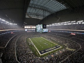 FILE - Fans watch at the start of an NFL football game inside AT&T Stadium between the New York Giants and Dallas Cowboys, on Sept. 8, 2013, in Arlington, Texas. The Dallas Cowboys sparked criticism on social media Tuesday, July 5, 2022, after announcing a marketing agreement with a gun-themed coffee company with blends that include "AK-47 Espresso," "Silencer Smooth" and "Murdered Out." The partnership with the Black Rifle Coffee Co. was revealed on Twitter the day after six people died in a shooting at a Fourth of July parade in suburban Chicago.