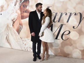 FILE - Cast member Jennifer Lopez, right, and Ben Affleck attend a photo call for a special screening of "Marry Me" at DGA Theater on Feb. 8, 2022, in Los Angeles. The couple have obtained a marriage license in Nevada, according to court records posted Sunday, July 17, 2022.