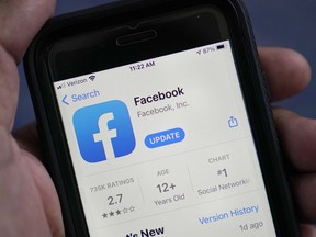 FILE - The Facebook app is shown in the app store on a smart phone in Surfside, Fla., on April 23, 2021. According to a new report from the nonprofit groups Global Witness and Foxglove, Facebook is letting violent hate speech slip through its controls in Kenya as it has in other countries. It is the third such test of Facebook's ability to detect hateful language -- either via artificial intelligence or human moderators -- that the groups have run, and that the company has failed.