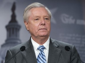 FILE - Sen. Lindsey Graham, R-S.C., speaks with reporters about aid to Ukraine, on Capitol Hill, Wednesday, March 10, 2022, in Washington. The Georgia prosecutor investigating the conduct of former President Donald Trump and his allies after the 2020 election is trying to compel U.S. Sen. Graham and former New York Mayor Rudy Giuliani to testify before a special grand jury. Fulton County District Attorney Fani Willis on Tuesday, July 5, 2022, filed petitions with the judge overseeing the special grand jury.