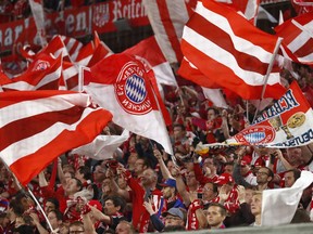 FILE - Bayern fans wave flags prior to the semifinal first leg soccer match between FC Bayern Munich and Real Madrid at the Allianz Arena stadium in Munich, Germany, Wednesday, April 25, 2018. Bayern Munich's chief executive Oliver Kahn has defended the German soccer club's contentious sponsorship agreement with Qatar. Kahn said Monday, July 4, 2022, he's sure their partnership has helped bring positive change to the oil-rich Persian Gulf state.