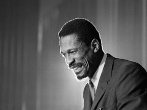 FILE - Bill Russell grins at announcement that he had been named coach of the Boston Celtics basketball team, April 18, 1966. (AP Photo, File)