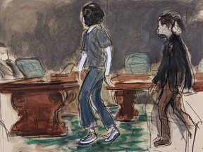 In this courtroom sketch, Ghislaine Maxwell, left, escorted by a U.S. Marshal, wears leg shackles as she enters the courtroom for her sentencing in federal court, Tuesday, June 28, 2022, in New York. Maxwell was sentenced on Tuesday to 20 years in prison for helping the wealthy financier Jeffrey Epstein sexually abuse teenage girls.
