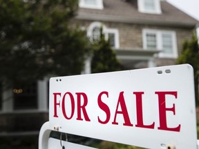 FILE - A "for sale" sign stands in front of a house in Pennsylvania, near Philadelphia, on June 8, 2018. A Pennsylvania mortgage company owned by billionaire businessman Warren Buffett discriminated against potential Black and Latino homebuyers in Philadelphia, New Jersey and Delaware, the Department of Justice said Wednesday, July 27, 2022, in what they are calling the second-largest redlining settlement in history.