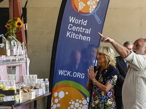 FILE - First lady Jill Biden and Spanish chef Jose Andres of the World Central Kitchen greet volunteers from the World Central Kitchen association during a visit to a reception center for Ukrainian refugees in Madrid, Spain, Tuesday, June 28, 2022. Donations from Fidelity Charitable climbed 11% to a record $4.8 billion for the first half of 2022, the nation's largest grantmaker announced Wednesday, July 20, 2022. Emergency relief organization International Medical Corps saw the number of Fidelity Charitable donors provide them a grant jump more than 1,000% compared to the first half of 2021, while World Central Kitchen grew more than 500%.