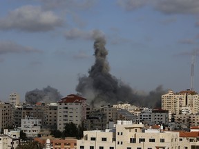 FILE - An Israeli air strike hits a building in Gaza City, May 17, 2021. The Israeli army said, Wednesday, July 27, 2022, that Hamas has rebuilt some of the capabilities that were damaged during last year's Gaza war, including three new tunnels and a series of weapons manufacturing and storage sites.