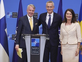 Finland's Foreign Minister Pekka Haavisto, left, Sweden's Foreign Minister Ann Linde, right, and NATO Secretary General Jens Stoltenberg attend a media conference after the signature of the NATO Accession Protocols for Finland and Sweden in the NATO headquarters in Brussels, Tuesday, July 5, 2022.