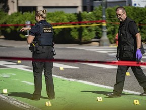 FILE - Police investigate an overnight fatal shooting in Portland, Ore., on July 17, 2021. The city's mayor on Thursday, July 21, 2022, declared a state of emergency due to spiking gun violence, with the goal to reduce fatal shootings by 10% over the next two years.