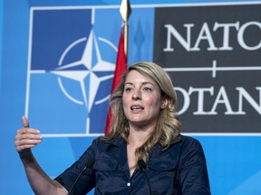 Foreign Affairs Minister Melanie Joly responds to a question during a news conference at the NATO Summit in Madrid on Wednesday, June 29, 2022. Canada has imposed a new round of sanctions on Russia's media machine designed to puncture disinformation campaigns about the war in Ukraine.