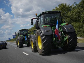 Demonstrating farmers slow down traffic on a motorway near Venlo, southern Netherlands, Monday, July 4, 2022. Dutch farmers angry at government plans to slash emissions used tractors and trucks Monday to blockade supermarket distribution centers, the latest actions in a summer of discontent in the country's lucrative agricultural sector.