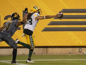 Hamilton Tiger Cats wide receiver Papi White (4) cannot catch Edmonton Elks defensive back Jalen Collins (33) who runs the ball into the end zone after recovering a fumble by Hamilton Tiger Cats quarterback Dane Evans, not shown, late in the fourth quarter of CFL football game action in Hamilton, Ont., Friday, July 1, 2022. Collins scored on a 14-yard return in the fourth quarter to give the Elks their first win of the season with a 29-25 win over the Tiger-Cats.