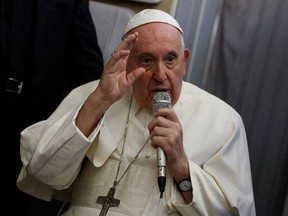 Pope Francis speaks to journalists aboard the papal plane on his flight back after visiting Canada, July 29, 2022.