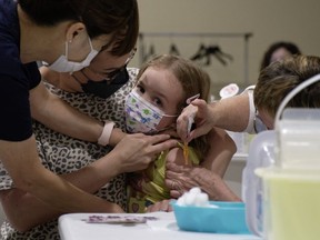 Khloe Robins, 3, gets a COVID-19 vaccination shot at a clinic in the Victoria Square Mall in Regina on Friday, July 22, 2022. It's the first day that children six-months to five-years-old can get a COVID-19 vaccination.