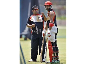 Canada's cricketer Zubin Surkari, right, listens to team coach Pubudu Dassanayake during a training session in Bangalore, India, Tuesday, March 15, 2011. Dassanayake is returning for a second stint as Canada men's cricket coach.