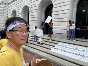 Kapsong Kim, an American citizen from New York, holds a Korean percussion instrument as he and others demonstrate outside the 5th U.S. Circuit Court of Appeals in New Orleans on Wednesday, July 6, 2022. A panel of 5th Circuit judges heard arguments on an Obama-era program that prevents the deportation of thousands of immigrants brought into the United States as children. A federal judge in Texas last year declared the Deferred Action for Childhood Arrivals program illegal -- although he agreed to leave the program intact for those already benefiting from it while his order is appeal.