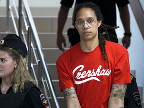 WNBA star and two-time Olympic gold medalist Brittney Griner is escorted to a courtroom for a hearing, in Khimki just outside Moscow, Russia, Thursday, July 7, 2022. Griner pleaded guilty Thursday to drug possession charges on the second day of her trial in a Russian court in a case that could see her sentenced to up to 10 years in prison.