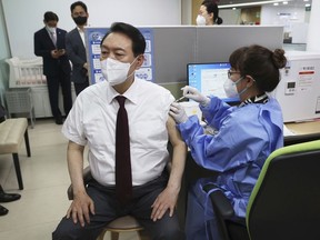 South Korean President Yoon Suk Yeol receives his fourth dose of the Pfizer COVID-19 vaccine at a public health center in Seoul, South Korea, Wednesday, July 13, 2022.