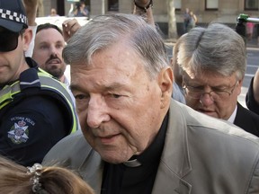FILE - Cardinal George Pell arrives at the County Court in Melbourne, Australia, on Feb. 27, 2019. The father of a deceased former choirboy filed a lawsuit against Cardinal George Pell and the Catholic Church in an Australian court on Thursday, July 14, 2022 claiming the parent suffered psychological injury over an accusation that the once-senior Vatican official sexually abused the son.