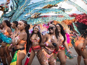Participants dance to music prior to the start of the Caribbean Carnival's grand parade in Toronto, on Saturday, July 30, 2022. The parade returned to the city after a two-year hiatus as a result of the COVID-19 pandemic.