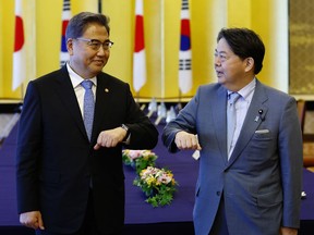 FILE - South Korean Foreign Minister Park Jin, left, and Japanese counterpart Yoshimasa Hayashi bump elbows before their talk in Tokyo, Monday, July 18, 2022. Hayashi said Tuesday he expects South Korea to take appropriate steps toward resolving the countries' wartime disputes over forced laborers and exploitation of women, warning that a mishandling would cause "grave" consequences for their bilateral ties.