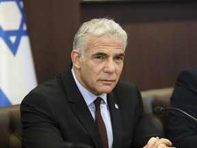 Israel's caretaker Prime Minister Yair Lapid chairs the first cabinet meeting in Jerusalem Sunday, July 3, 2022, days after lawmakers dissolved parliament.