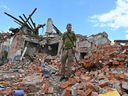 A Ukrainian serviceman inspects the ruins of a building destroyed after a missile strike near Kharkiv on July 5, 2022, amid the Russian invasion of Ukraine.