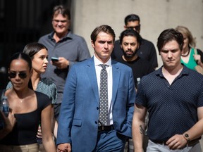Former Vancouver Canucks NHL hockey player Jake Virtanen, centre, leaves B.C. Supreme Court after testifying at his sexual assault trial, in Vancouver, on Thursday, July 21, 2022.