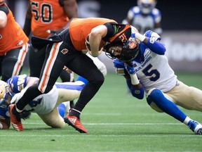 B.C. Lions quarterback Nathan Rourke (12) is sacked by Winnipeg Blue Bombers' Willie Jefferson (5) during the first half of CFL football game in Vancouver, on Saturday, July 9, 2022.