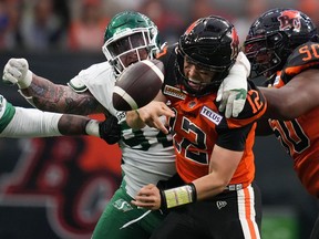 B.C. Lions quarterback Nathan Rourke is sacked by Saskatchewan Roughriders' Garrett Marino, back, and fumbles the ball during the first half of a pre-season CFL football game in Vancouver on June 3, 2022. The 4-3 Riders will host the 4-1 B.C. Lions on Friday, opening a run of eight straight games against West Division opponents.