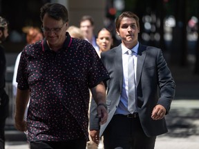 Former Vancouver Canucks NHL hockey player Jake Virtanen, right, returns to B.C. Supreme Court with his father Rainer after a lunch break in his sexual assault trial, in Vancouver, on Tuesday, July 19, 2022. A 23-year-old woman, whose identity is covered by a publication ban, told B.C. Supreme Court on Monday that Virtanen sexually assaulted her in a Vancouver hotel room in September 2017.