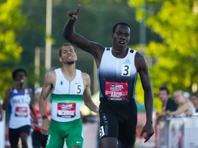 Marco Arop, front right, of Edmonton, Alta., celebrates his first place finish ahead of second place finisher Brandon McBride, of Windsor, Ont., in the men's 800 metre race at the Canadian Track and Field Championships in Langley, B.C., Saturday, June 25, 2022.