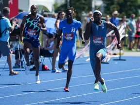 Aaron Brown, right, of Toronto, races to a first place finish in the men's 200 metre final at the Canadian Track and Field Championships in Langley, B.C., on Sunday, June 26, 2022.&ampnbsp;Brown qualified tonight for the men's 200-metre final at the world track and field championships in Eugene, Oregon.