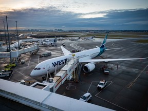 A WestJet Airlines Boeing 787-9 Dreamliner is seen parked at a gate at Vancouver International Airport, in Richmond, B.C., on Thursday, January 21, 2021.