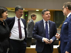 Czech Republic's Finance Minister Zybnek Stanjura, right, speaks with Ireland's Finance Minister Paschal Donohoe, second right, during a meeting of EU finance ministers in Brussels, Tuesday, July 12, 2022. The European Union is set on Tuesday to remove the final obstacles for Croatia to adopt the euro, ensuring the first expansion of the currency bloc in almost a decade.