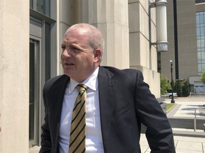 Paul T. Farrell Jr., an attorney representing plaintiffs in a lawsuit against three major U.S. drug distributors, speaks to reporters Wednesday, July 28, 2021, outside the federal courthouse in Charleston, W.Va. Attorneys finished giving closing arguments in the case brought by Cabell County and the city of Huntington accusing AmerisourceBergen, Cardinal Health and McKesson of creating a public nuisance by distributing 81 million pills over eight years.