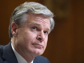 FILE - Director of the Federal Bureau of Investigation Christopher Wray testifies during a Senate Appropriations Subcommittee hearing on the fiscal year 2023 budget for the FBI in Washington, May 25, 2022. The head of the FBI and the leader of Britain's domestic intelligence agency are raising fresh alarms about the Chinese government in a joint appearance. They're warning business leaders Wednesday, July 6, that Beijing is determined to steal their technology for competitive gain.