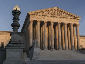 FILE - The Supreme Court is seen at sundown in Washington, on Nov. 6, 2020. The Supreme Court won't allow the Biden administration to implement a policy that prioritizes deportation of people in the country illegally who pose the greatest public safety risk. The court's order on July 21, 2022, leaves the policy frozen nationwide for now.