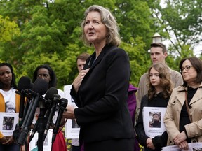 FILE - Elizabeth Whelan, sister of U.S. Marine Corps veteran and Russian prisoner Paul Whelan, speaks at a news conference alongside families of Americans currently being held hostage or wrongfully detained overseas in Lafayette Park near the White House, May 4, 2022, in Washington. President Joe Biden spoke by phone July 8 with Elizabeth Whelan according to the White House. Biden's phone call came after Biden and Vice President Kamala Harris spoke earlier this week to the wife of WNBA star Brittney Griner, who has been held for more than four months in Russia.