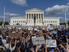 Abortion-rights and anti-abortion demonstrators gather outside of the Supreme Court in Washington, Friday, June 24, 2022. The Supreme Court has ended constitutional protections for abortion that had been in place nearly 50 years, a decision by its conservative majority to overturn the court's landmark abortion cases. Abortion, guns and religion _ a major change in the law in any one of these areas would have made for a fateful Supreme Court term. In its first full term together, the court's conservative majority ruled in all three and issued other significant decisions limiting the government's regulatory powers.