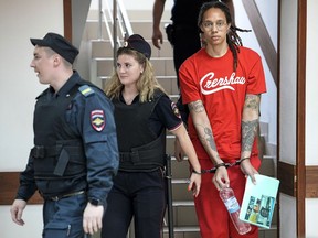 WNBA star and two-time Olympic gold medalist Brittney Griner is escorted to a courtroom for a hearing, in Khimki just outside Moscow, Russia, Thursday, July 7, 2022. Jailed American basketball star Brittney Griner returns to a Russian court on Thursday amid a growing chorus of calls for Washington to do more to secure her release nearly five months after being arrested on drug charges.