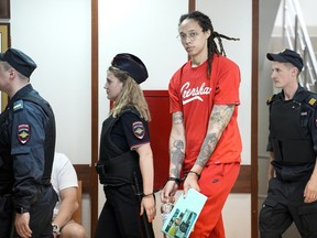 WNBA star and two-time Olympic gold medalist Brittney Griner is escorted to a courtroom for a hearing, in Khimki outside Moscow, Russia, Thursday, July 7, 2022. Griner on Thursday pleaded guilty to drug possession and smuggling during her trial in Moscow but said she had no intention of committing a crime, Russian news agencies reported.