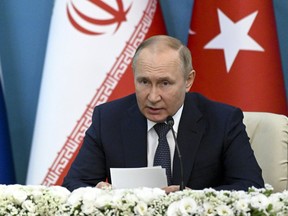 Russian President Vladimir Putin attends a joint news conference with Iranian President Ebrahim Raisi and Turkish President Recep Tayyip Erdogan following their talks at the Saadabad palace, in Tehran, Iran, Tuesday, July 19, 2022.