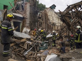 Rescuers remove debris following a Russian missile attack in Chuhuiv, Kharkiv region, Ukraine, Monday, July 25, 2022.